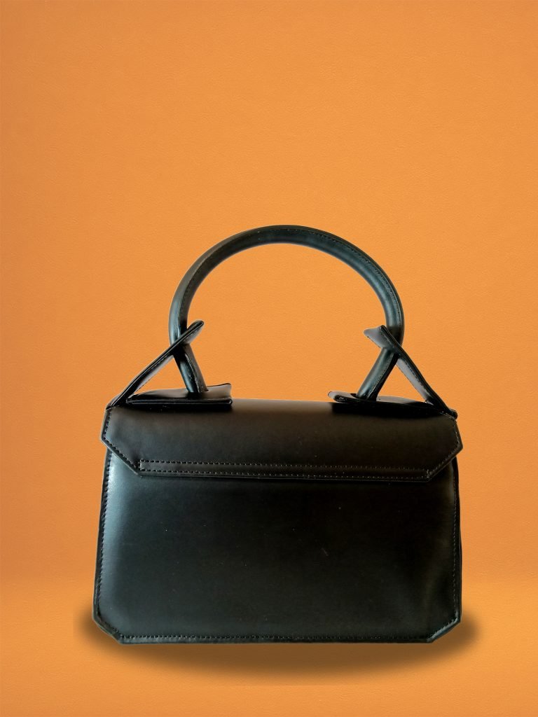 Back view of the Miacontessa origami style Intramontabile handbag in obsidian black Italian leather, featuring its structured silhouette and unique folded detailing.