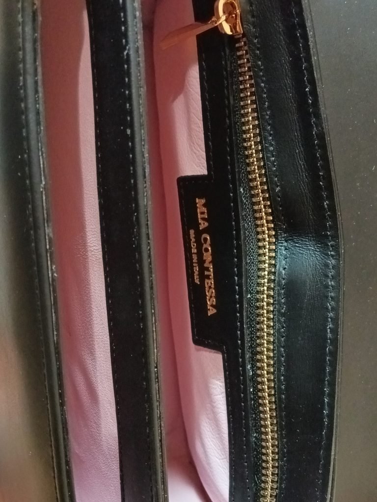Inside view of the Miacontessa origami style Intramontabile handbag in obsidian black Italian leather, featuring its structured silhouette and unique folded detailing.