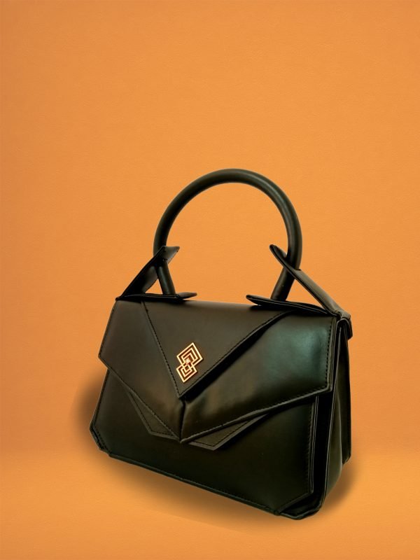 Side view of the Miacontessa origami style Intramontabile handbag in obsidian black Italian leather, featuring its structured silhouette and unique folded detailing.