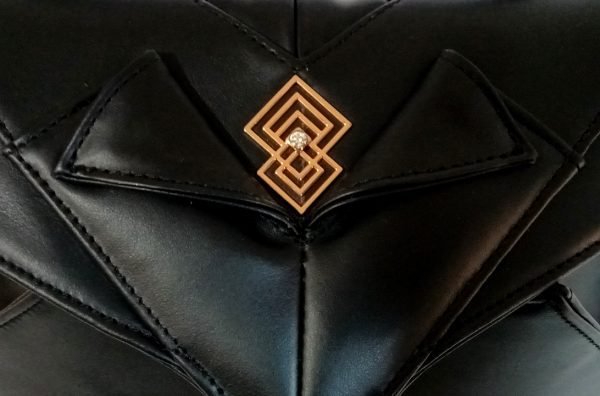 Closeup view of Miacontessa Amore origami style handbag in obsidian black Italian leather, highlighting its unique, folded design that creates an illusionary or artful aesthetic.