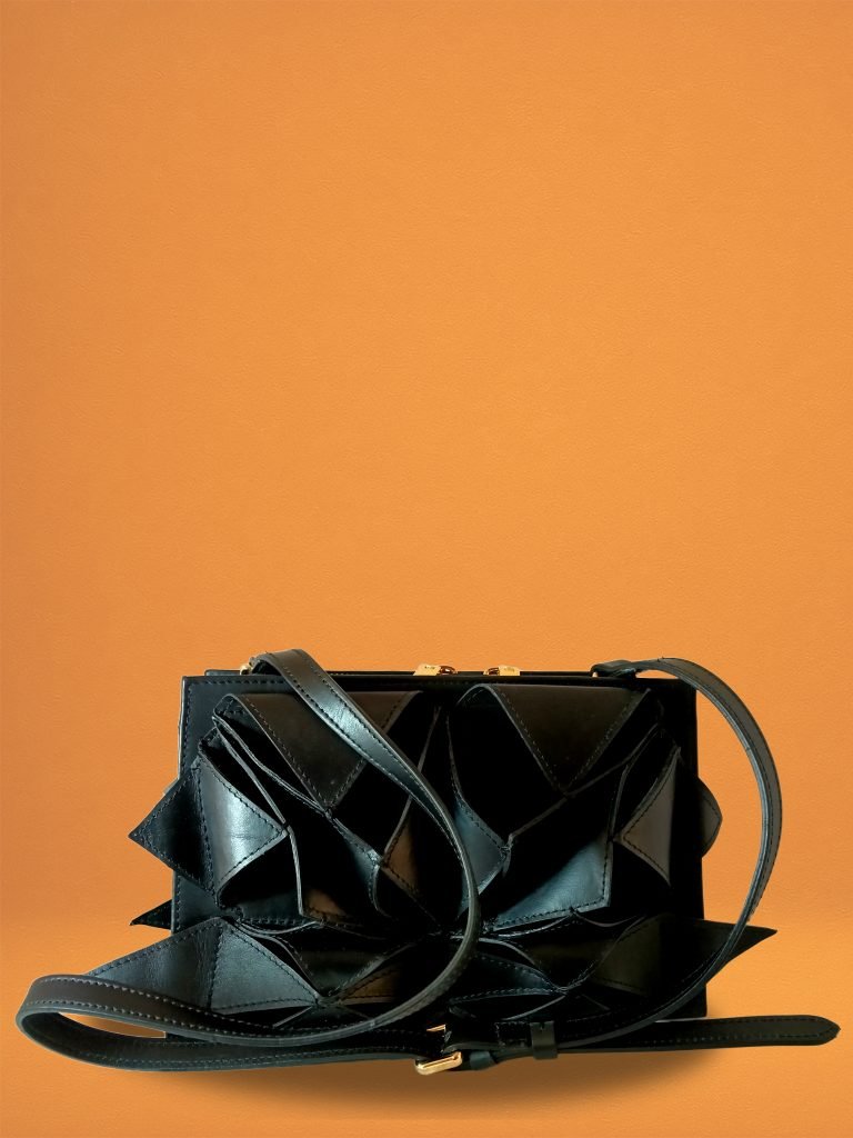 Back view of Miacontessa Arte origami style handbag in obsidian black Italian leather, highlighting its unique, folded design that creates an illusionary or artful aesthetic.