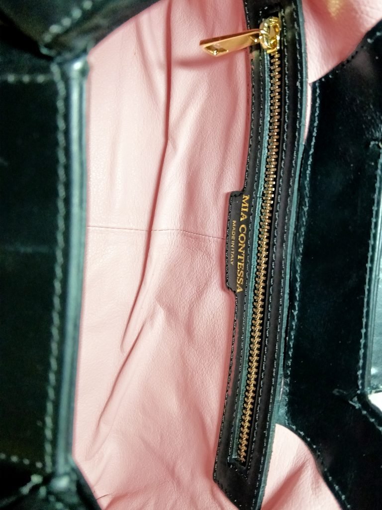 Inside view of Black Italian leather Miacontessa Dea handbag featuring a unique origami style geometric, folded design.