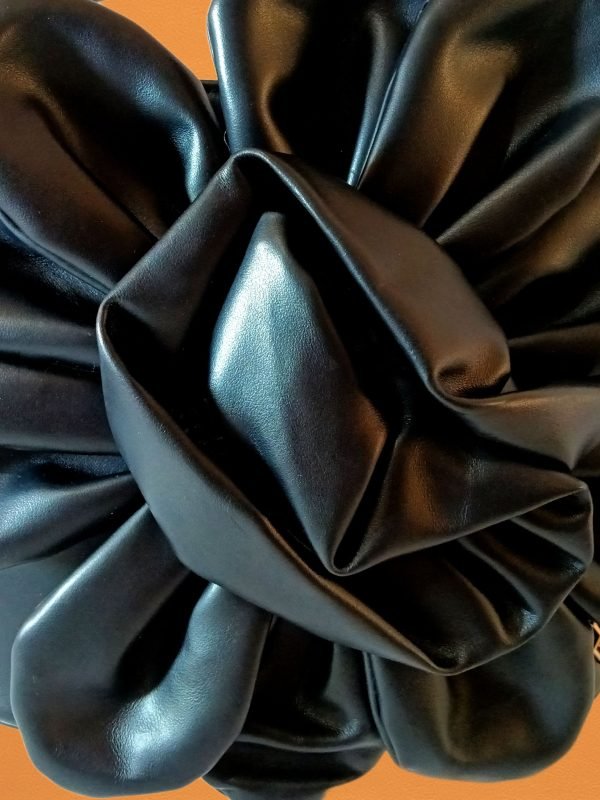 Closeup view of Miacontessa Florella origami style handbag in obsidian black Italian leather, highlighting its unique, folded design that creates an illusionary or artful aesthetic.