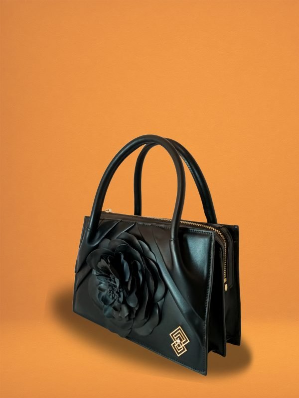 Side view of Miacontessa Florella Rosa origami style handbag in obsidian black Italian leather, highlighting its unique, folded design that creates an illusionary or artful aesthetic.