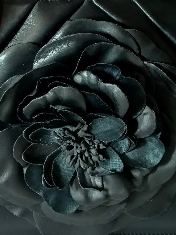 Closeup view of Miacontessa Florella Rosa origami style handbag in obsidian black Italian leather, highlighting its unique, folded design that creates an illusionary or artful aesthetic.