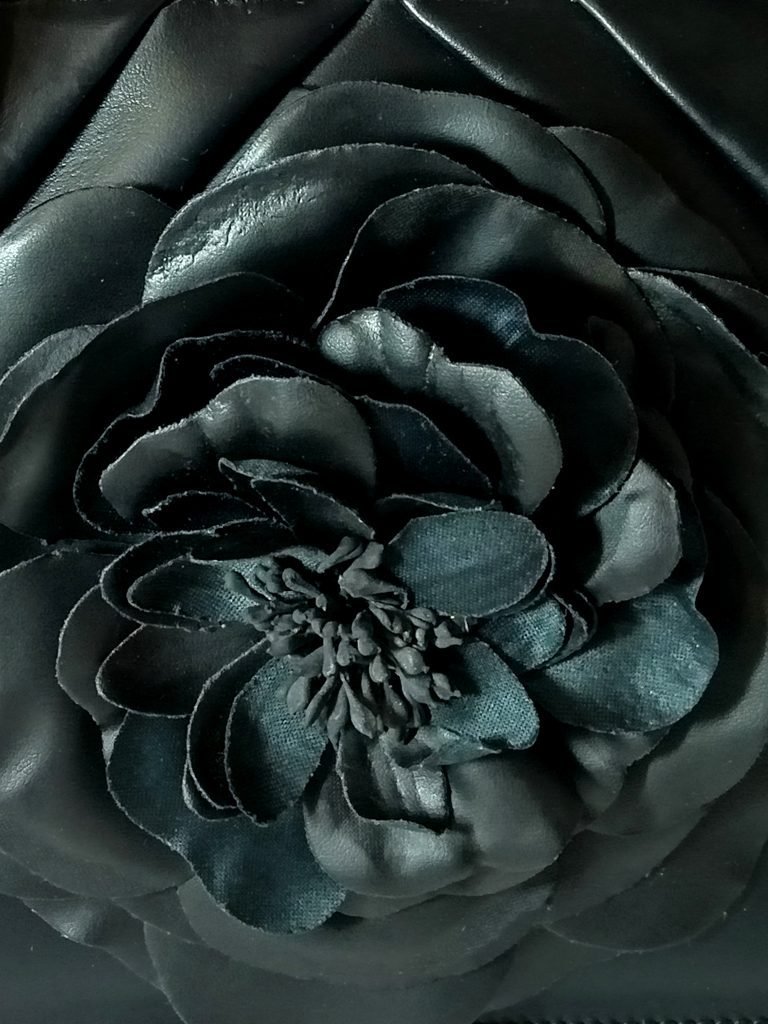 Closeup view of Miacontessa Florella Rosa origami style handbag in obsidian black Italian leather, highlighting its unique, folded design that creates an illusionary or artful aesthetic.