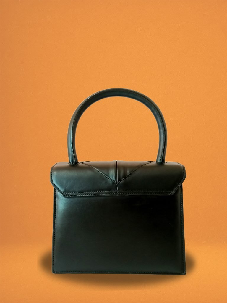 Back view of Miacontessa Magia origami style handbag in obsidian black Italian leather, highlighting its unique, folded design that creates an illusionary or artful aesthetic.