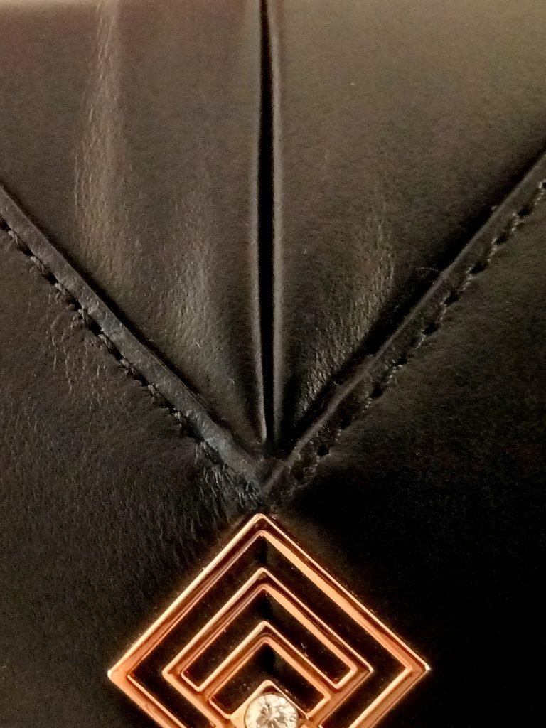 Closeup view of Miacontessa Magia origami style handbag in obsidian black Italian leather, highlighting its unique, folded design that creates an illusionary or artful aesthetic.