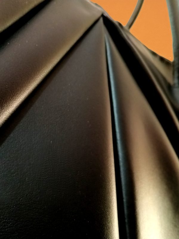 Closeup view of Miacontessa Tesoro origami style handbag in obsidian black Italian leather, highlighting its unique, folded design that creates an illusionary or artful aesthetic.